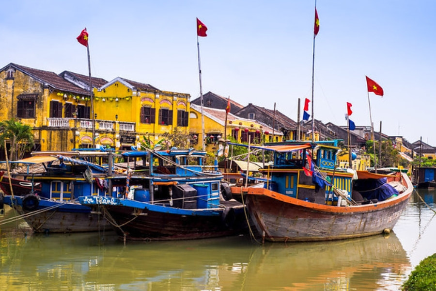 Colorful fishing boats docked on river in Hoi An Ancient Town Vietnam
